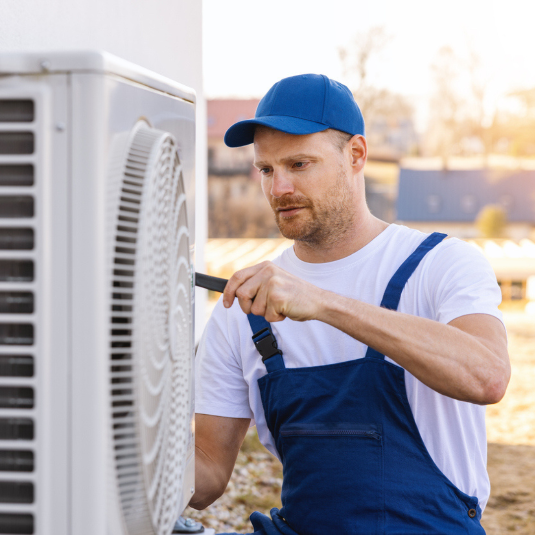 man wearing blue and white fixing a white heat plump